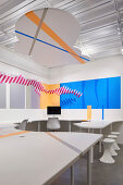 Graphic design on desk and wall in office with cloud-shaped suspended ceiling at HARU Gallery, London, United Kingdom