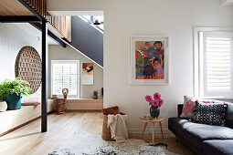 Upholstered sofa with cushions and side table in open living room