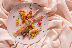 Homemade rice with crayfish and prawns on pink background