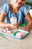 Girl making marshmallow flowers