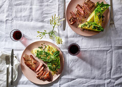 Sirloin steaks with romaine lettuce and pistachios