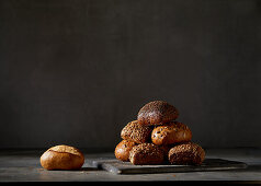 Various bread rolls in front of a dark background