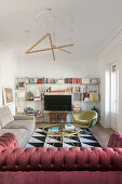 Various upholstered furnishings and TV on shelving in living room