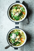 Vegetable soup with orecchiette pasta and grated cheese