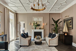 Two sofas facing one another in front of fireplace in elegant living room