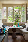 Corner bench below window in kitchen of period apartment