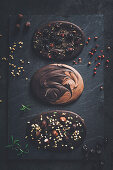 Homemade chocolate with nuts, brittle, berries and pepper