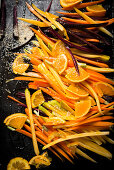 Strips of various carrots and purple carrots on a baking tray
