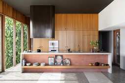 Kitchen island in front of an oak kitchen in an open living room