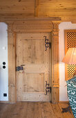 Solid wooden door with iron fittings in traditional Swiss farmhouse