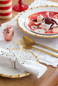 Festive place settings with gnome and gold cutlery
