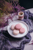 Pink macarons a white cake stand