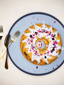 Berry bundt cake with freeze dried berries and edible rose petals
