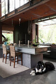Open kitchen in industrial style with kitchen island made of steel beams