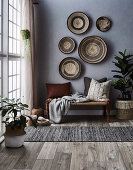 Basket bowls on the gray wall above the bench with pillows