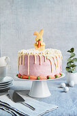 Easter cake with Easter Bunny biscuits and marzipan carrots