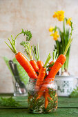 A table decoration with carrots and daffodils