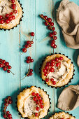 Puff pastry tartlets with chocolate and mascarpone cream and redcurrants