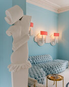 Contemporary stucco ornamentation in open doorway of luxurious interior with sky-blue sofa combination
