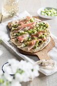 Tarte flambée with spring onions and ham