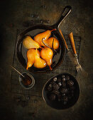 Poached pears with honey and vanilla served with berries