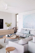 Gray corner sofa and wooden furniture in the living room in natural tones