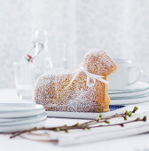 Baked Easter lamb with powdered sugar and bows on a table