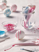 Decorating cake pops with icing and sugar sprinkles