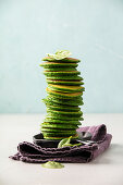 Spinach pancakes stack on blue background
