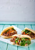 Chinese steamed buns with pulled pork and pickled carrot and apple