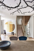 View over dining table to staircase in open-plan interior