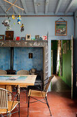 Terracotta floor tiles and fireplace in rustic dining room