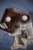Old newspaper, tray, coffee cups, candles and key