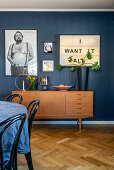 Retro sideboard in interior with blue wall