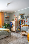 Changing table and chest of drawers in room with pale grey walls