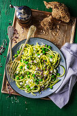 Zucchini spaghetti with feta and peas