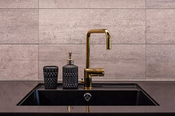Golden tap fitting and soap dispenser with structured surface on sink