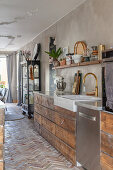 Stylish kitchen with wooden units and brick floor