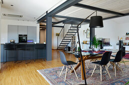 Modern loft apartment with staircase leading to mezzanine on steel joists