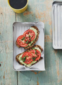 Grilled bread with avocado cream and tomatoes