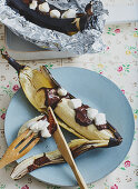 Grilled bananas with chocolate sauce and marshmallows