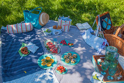 Handmade fabric accessories and snacks on picnic blanket