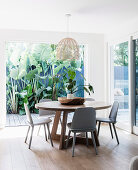 Round table with chairs in front of an open patio door