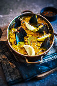 Bobotie with mussels in a pan (South Africa)