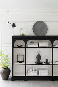 Oriental ornaments on black shelves with white interior