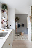 View from kitchen into hallway with tiled and wooden floor sections