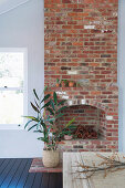 Branches in front of the rustic open brick fireplace