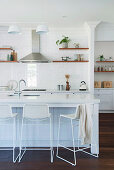 Filigree bar stools on the kitchen island in the open kitchen