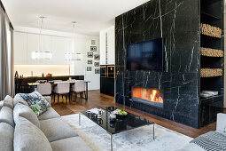 Marble wall with integrated fireplace below TV in elegant interior