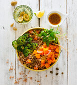 A buckwheat bowl with broccoli, olives, pumpkin and mint